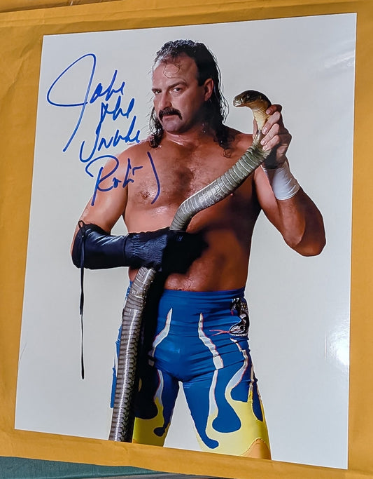 + Jake “The Snake” Roberts Signed WWE 8x10 Color Photo (Comes w/COA)